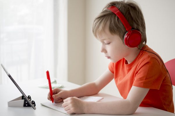 boy-wearing-headphones-and-writes