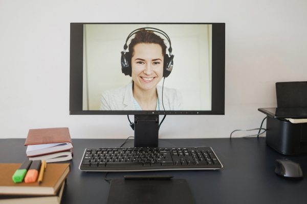 front-view-of-computer-with-woman-ready-for-online-class